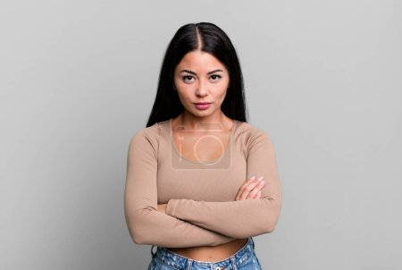 Photo for Pretty latin woman feeling displeased and disappointed, looking serious, annoyed and angry with crossed arms - Royalty Free Image