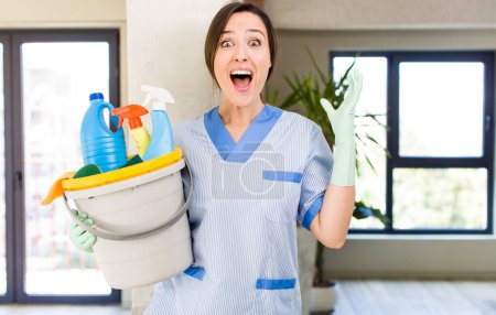 Téléchargez les photos : Young pretty woman feeling happy and astonished at something unbelievable. housekeeper concept - en image libre de droit