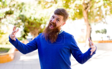 Photo for Red hair bearded man looking happy, arrogant, proud and self satisfied, feeling like a number one - Royalty Free Image