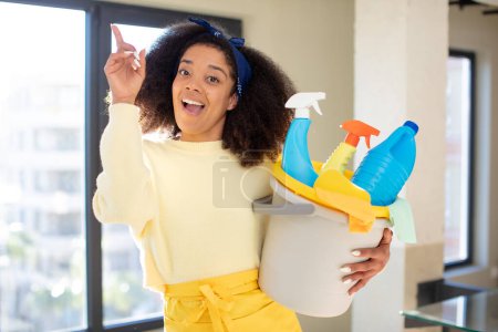 Photo for Pretty afro black woman feeling like a happy and excited genius after realizing an idea. housekeeper cleaner concept - Royalty Free Image