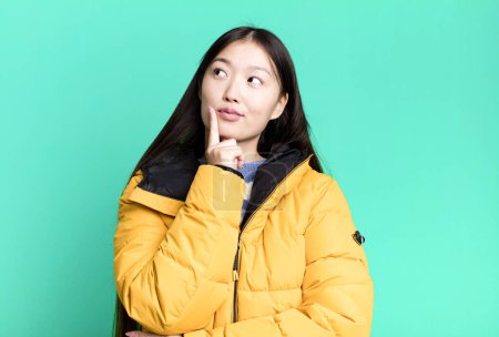 Photo for Young adult pretty asian woman wearing anorak. winter and cold concept - Royalty Free Image