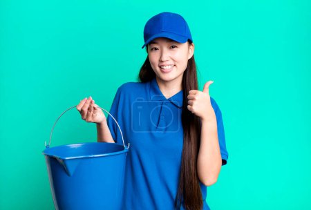 Téléchargez les photos : Young adult pretty asian woman. housekeeper and cleaning concept - en image libre de droit