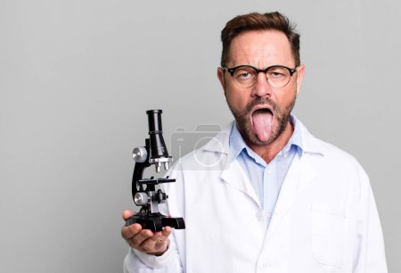 Photo for Middle age man feeling disgusted and irritated and tongue out. scientist concept - Royalty Free Image
