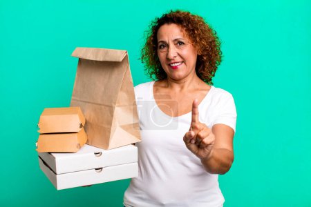 Photo for Smiling proudly and confidently making number one. take away fast food delivery concept. - Royalty Free Image