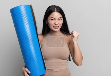 Photo for Hispanic pretty woman shouting aggressively with an angry expression yoga concept - Royalty Free Image