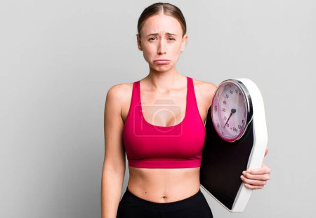 Photo for Caucasian pretty woman feeling sad and whiney with an unhappy look and crying. fitness and diet concept - Royalty Free Image