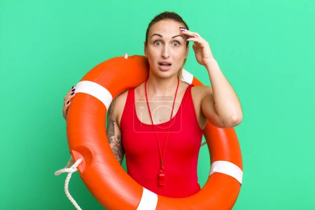 Photo for Young pretty woman looking happy, astonished and surprised. summer and lifeguard concept - Royalty Free Image