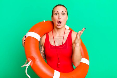 Photo for Young pretty woman feeling extremely shocked and surprised. summer and lifeguard concept - Royalty Free Image