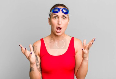 Photo for Young pretty woman feeling extremely shocked and surprised. swimmer concept - Royalty Free Image