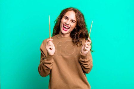 Photo for Hispanic pretty young woman eating a japanese noodles bowl. - Royalty Free Image