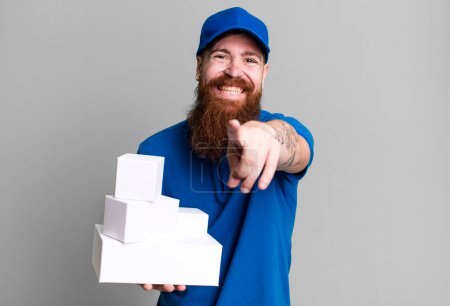 Photo for Young adult red hair bearded cool delivery man with boxes - Royalty Free Image