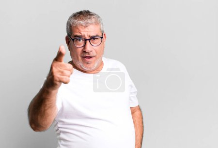 Photo for Middle age senior man pointing at camera with an angry aggressive expression looking like a furious, crazy boss - Royalty Free Image