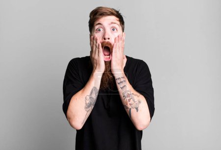 Photo for Long beard and red hair man feeling shocked and scared - Royalty Free Image