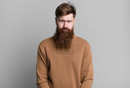 Photo for Long beard and red hair man feeling sad and whiney with an unhappy look and crying - Royalty Free Image