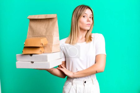 Photo for Young pretty woman shrugging, feeling confused and uncertain. delivery and take away food concept - Royalty Free Image