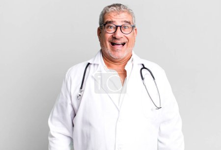 Téléchargez les photos : Homme âgé d'âge moyen regardant heureux et agréablement surpris. concept médecin ou médecin - en image libre de droit