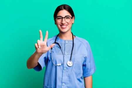 Photo for Smiling and looking friendly, showing number three. nurse concept - Royalty Free Image