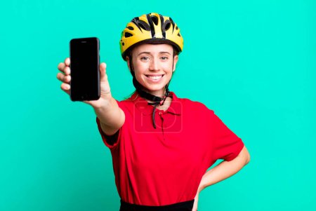 Photo for Delivery pretty blonde woman with a smartphone - Royalty Free Image