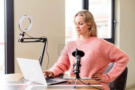 Photo for Pretty young woman working at home with a laptop. house interior design - Royalty Free Image