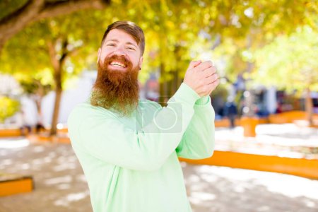 Photo for Red hair bearded man feeling happy, surprised and proud, shouting and celebrating success with a big smile - Royalty Free Image