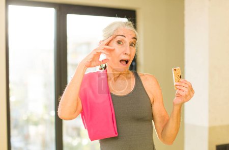 Photo for Senior pretty woman looking happy, astonished and surprised. fitness concept - Royalty Free Image