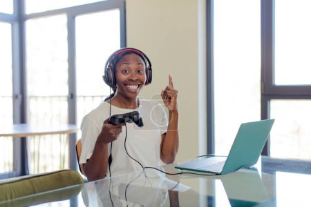 Photo for Black afro woman feeling like a happy and excited genius after realizing an idea. gamer concept - Royalty Free Image