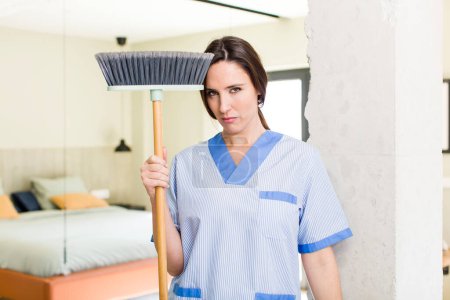 Photo for Young pretty woman feeling sad, upset or angry and looking to the side. housekeeper concept - Royalty Free Image
