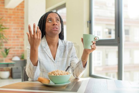 Photo for Black afro woman screaming with hands up in the air. breakfast concept - Royalty Free Image