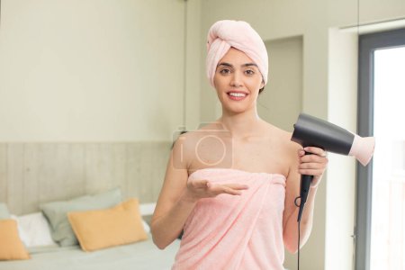 Photo for Pretty young model smiling cheerfully, feeling happy and showing a concept. hair dryer concept - Royalty Free Image