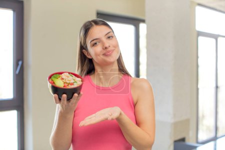 Photo for Young pretty woman smiling cheerfully, feeling happy and showing a concept. japanese ramen concept - Royalty Free Image