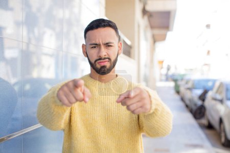 Photo for Young handsome man pointing forward at camera with both fingers and angry expression, telling you to do your duty - Royalty Free Image