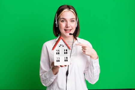 Photo for Young pretty agent woman with a house model. real state concept - Royalty Free Image