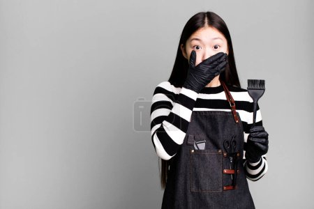 Photo for Pretty asian woman covering mouth with hands with a shocked. barber concept - Royalty Free Image