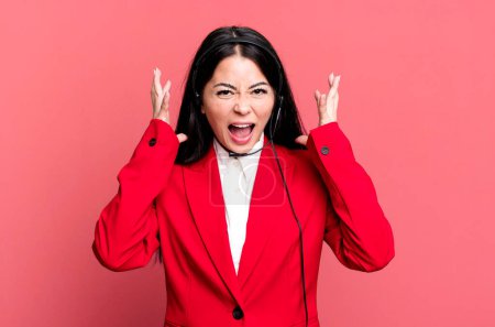 Photo for Hispanic pretty woman screaming with hands up in the air. telemarketing concept - Royalty Free Image