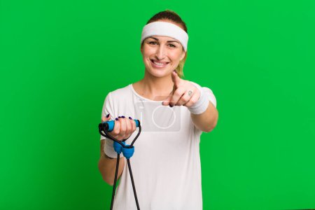 Photo for Young pretty woman pointing at camera choosing you. fitness concept - Royalty Free Image