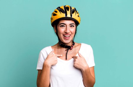 Téléchargez les photos : Se sentir heureux et pointant vers soi-même avec un excité. concept de casque de vélo - en image libre de droit