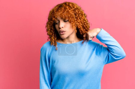 Photo for Redhair pretty woman feeling stressed, anxious, tired and frustrated, pulling shirt neck, looking frustrated with problem - Royalty Free Image