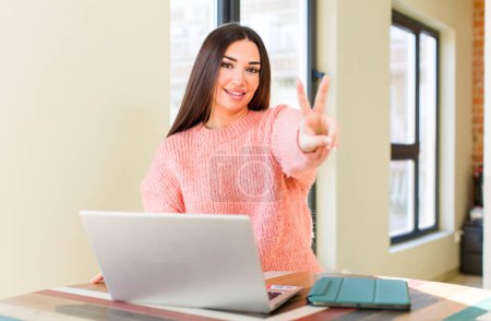 Photo for Pretty young woman with a laptop on a desk  at home - Royalty Free Image