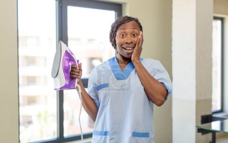 Foto de Negro afro mujer sintiéndose feliz y asombrado por algo increíble. concepto de lavandería y limpieza - Imagen libre de derechos