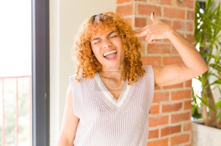Téléchargez les photos : Jeune roux cheveux latins jolie femme à nouveau cool maison - en image libre de droit