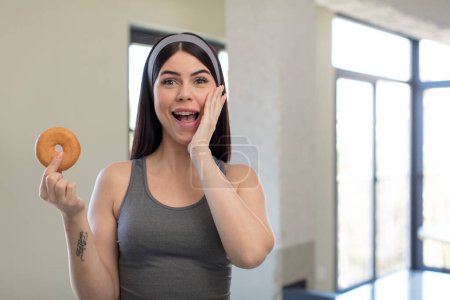 Photo for Pretty young woman feeling happy and astonished at something unbelievable. donut concept - Royalty Free Image