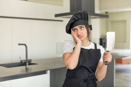 Photo for Young woman feeling bored, frustrated and sleepy after a tiresome. chef concept - Royalty Free Image