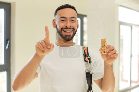 Photo for Arab handsome man arab man feeling like a happy and excited genius after realizing an idea.  fitness and cereal bar concept - Royalty Free Image