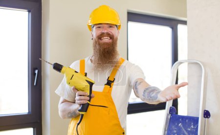 Photo for Red hair man smiling happily and offering or showing a concept repairing home. handyman concept - Royalty Free Image