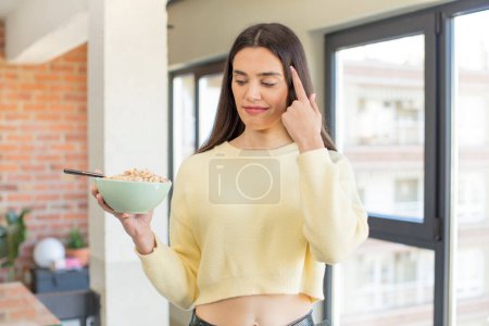 Photo for Pretty young model looking surprised, realizing a new thought, idea or concept. breakfast bowl concept - Royalty Free Image