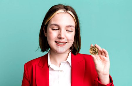 Photo for Young pretty businesswoman with a bitcoin - Royalty Free Image