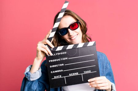 Photo for Young pretty woman holding a clapper cinema board - Royalty Free Image