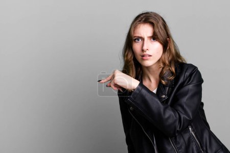 Photo for Caucasian pretty blonde woman wearing a leather jacket - Royalty Free Image