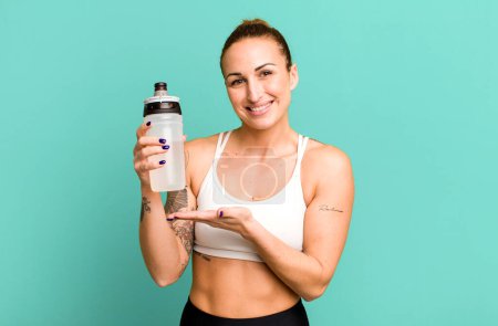 Foto de Young pretty woman with water bottle. fitness concept - Imagen libre de derechos