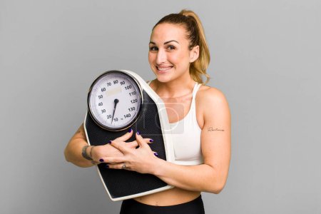 Photo for Young pretty woman with a scale. diet and fitness concept - Royalty Free Image